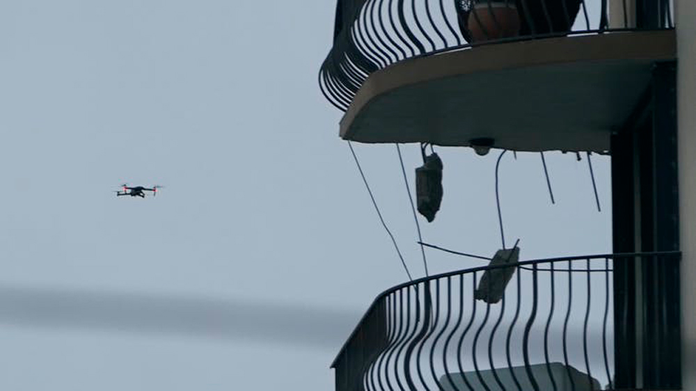 Drone in flight inspecting the upper floors of the remaining portion of the Champlain Towers South Condo building.